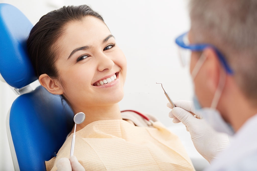 Dental Patient Smiling During Teeth Cleaning